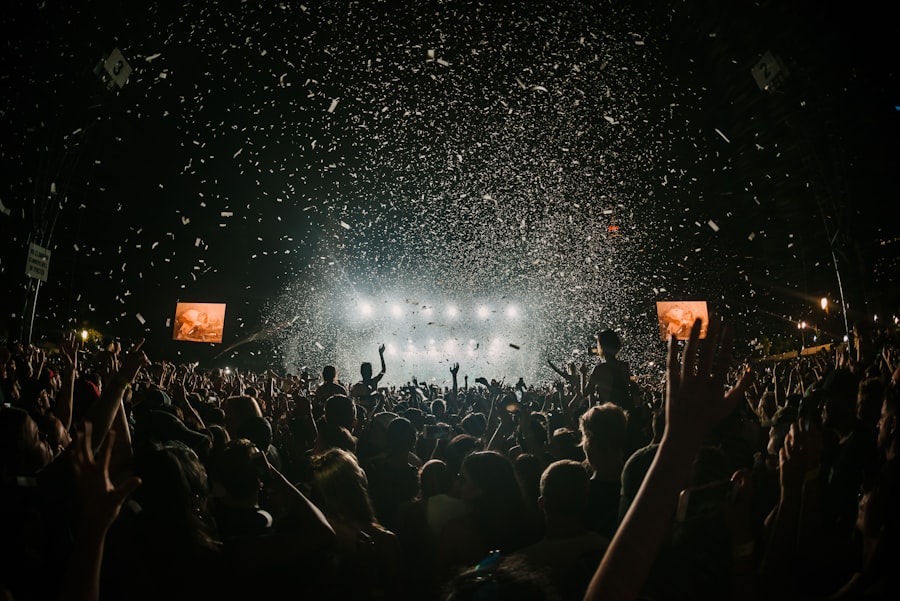 Confetti falling over a crowd at a music festival stage