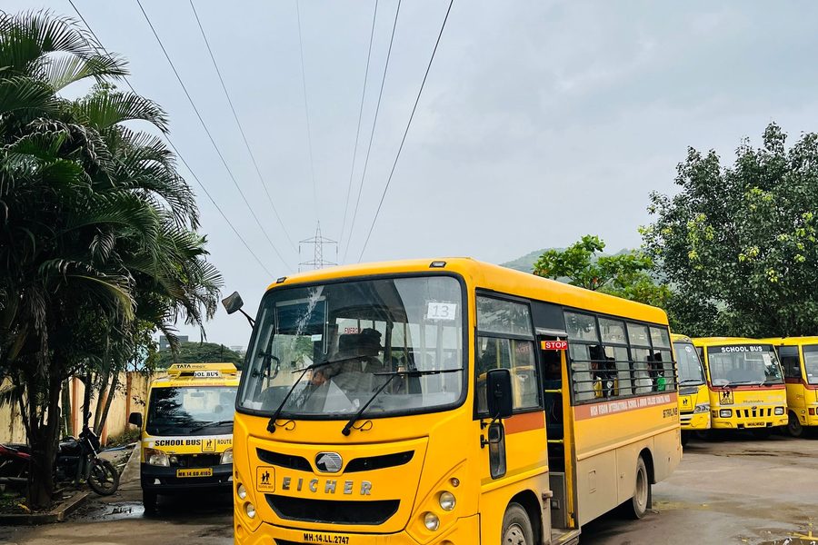 Yellow school buses parked in a row in India