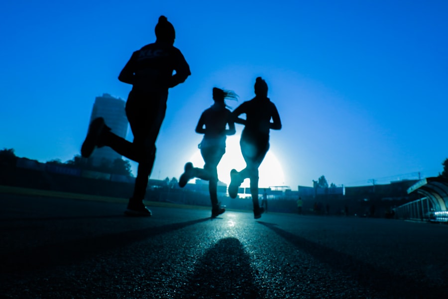 Marathon runners silhouetted against the sunrise sky